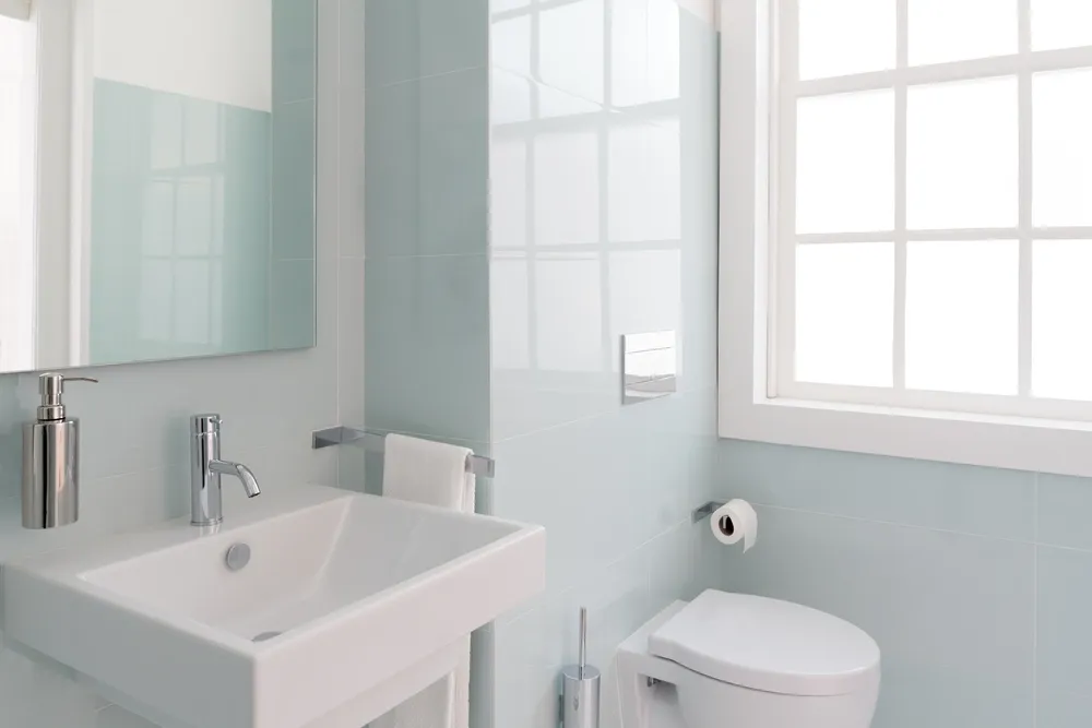 small bathroom with bright pastel green tile